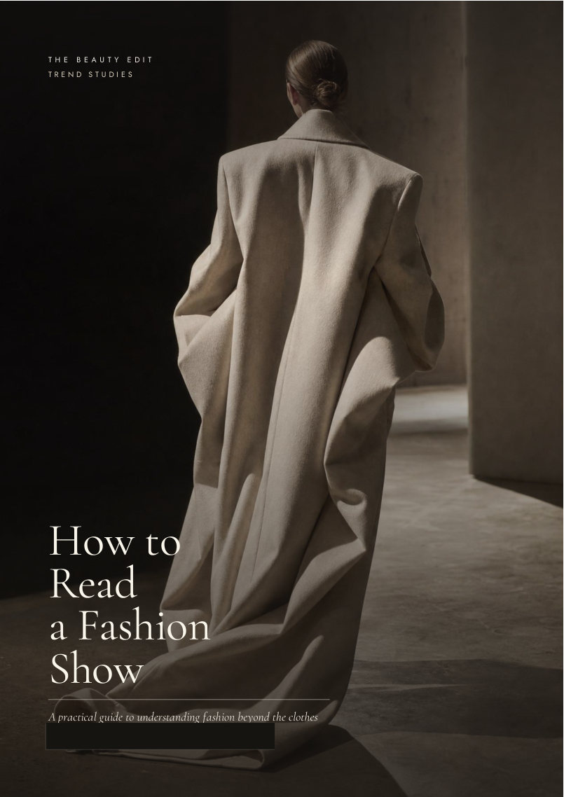 Model in an architectural ivory coat on the cover of How to Read a Fashion Show